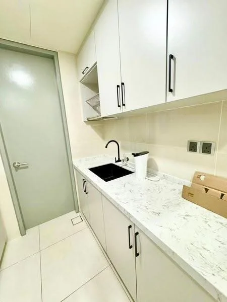 Kitchen features: white cabinetry with black handles, marble countertop, single-bowl black sink, chrome pull-down faucet, built-in shelving above countertop, light-colored tiled flooring, grey door, two electrical outlets, minimalist design; style: modern.
