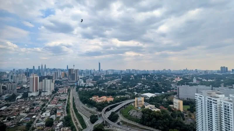 Exterior type: high-rise condominium; features: city skyline view, surrounded by greenery, high-rise buildings in the background, highway visible, urban landscape, mixed-use development, varied architectural styles, open sky; style: modern.