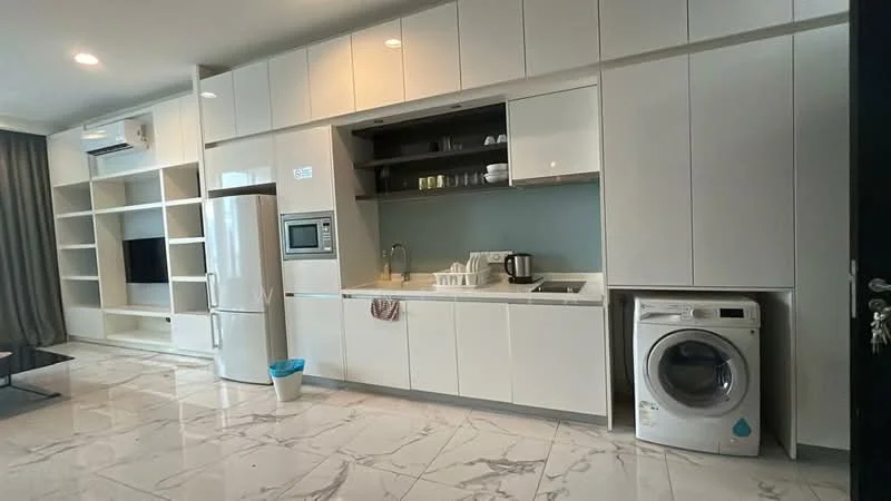 Kitchen features: white cabinetry, built-in oven, stainless-steel fridge, single-bowl stainless-steel sink, chrome pull-down faucet, white countertop, microwave, washing machine, marble tile flooring, recessed downlights, open shelving, wall-mounted TV, decorative items on shelves; style: modern.