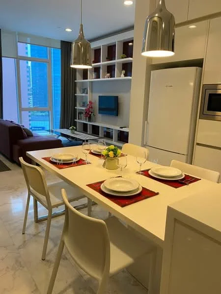 Dining features: white dining table, 4 white dining chairs, red placemats, decorative flower vase, pendant lighting, marble flooring, built-in shelving unit, wall-mounted TV, sofa in background, large windows with city view; style: modern; view: city.