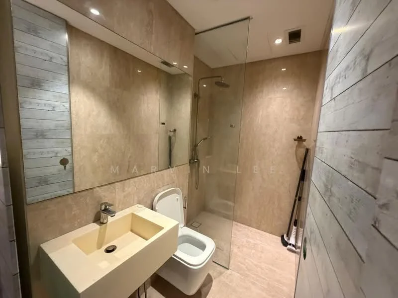 Bathroom features: walk-in shower with glass enclosure, rain shower head, single-sink vanity with integrated basin, chrome basin mixer, framed mirror, one-piece toilet, tile cladding on walls, light-colored tile flooring, recessed downlights, wall-mounted shower controls, towel rack; style: modern.