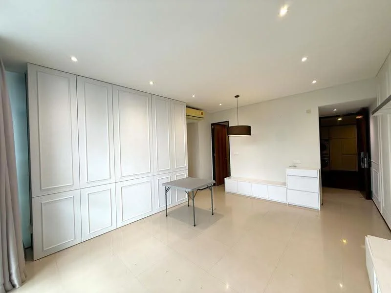 Room features: white paneled walls, cream tiled flooring, recessed downlights, ceiling light fixture, built-in cabinetry, foldable table, white storage unit, air conditioning unit; style: modern.