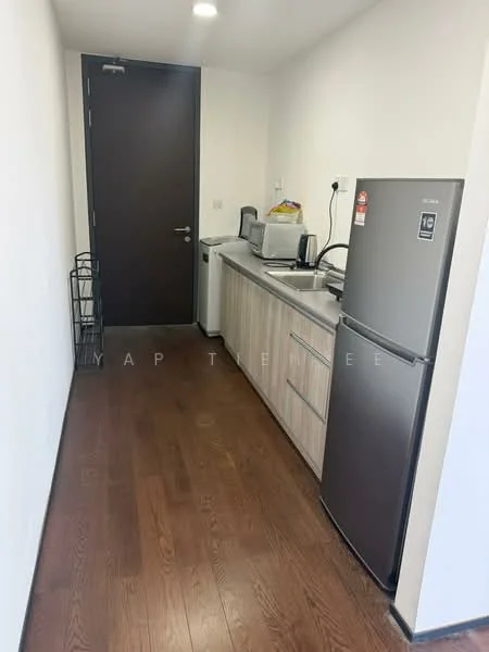 Kitchen features: wooden flooring, white painted walls, single-bowl stainless-steel sink, chrome pull-down faucet, grey laminate countertop, built-in microwave, stainless-steel fridge, kitchen cabinets with wood finish, wall-mounted electrical outlets, recessed ceiling lights; style: modern.