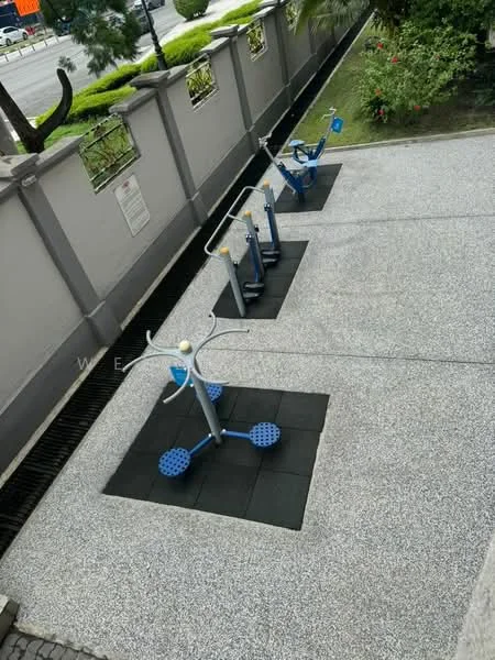 Exterior type: landscape garden; features: outdoor fitness equipment, rubberized flooring, landscaped garden area, paved walkway, surrounding greenery, fenced perimeter; style: modern.