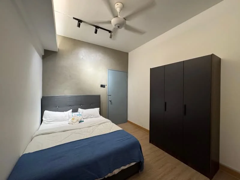 Bedroom features: queen-size bed, upholstered headboard, white bedding, blue throw blanket, wooden wardrobe in dark finish, light wood flooring, grey accent wall, ceiling fan with light, track lighting, white painted walls, door with handle; style: modern.
