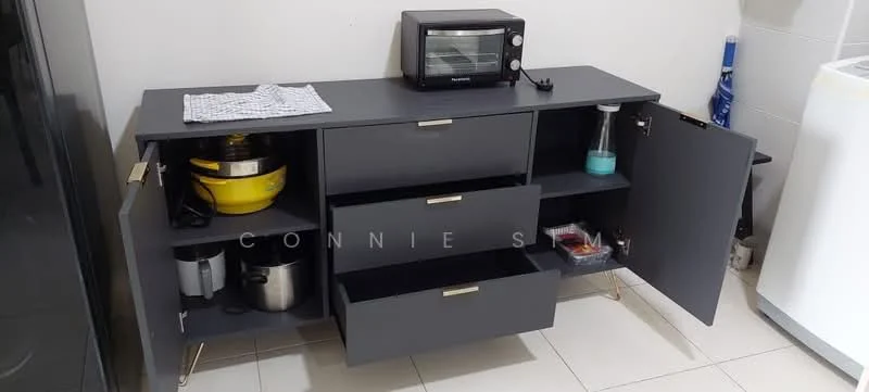 Room features: dark grey cabinetry, metal handles, open shelving, two closed cabinets, three drawers, microwave, yellow mixing bowl, stainless-steel pot, cleaning supplies, white countertop, tile flooring; style: modern.