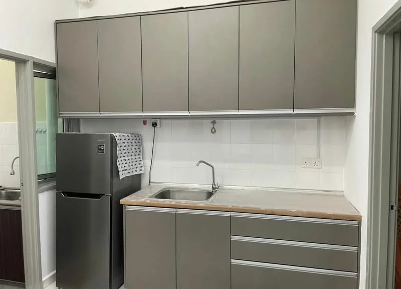 Kitchen features: grey cabinetry with upper and lower storage, stainless-steel sink, chrome faucet, countertop with wood finish, built-in refrigerator, white tiled backsplash, wall-mounted electrical outlets, window for natural light; style: modern.