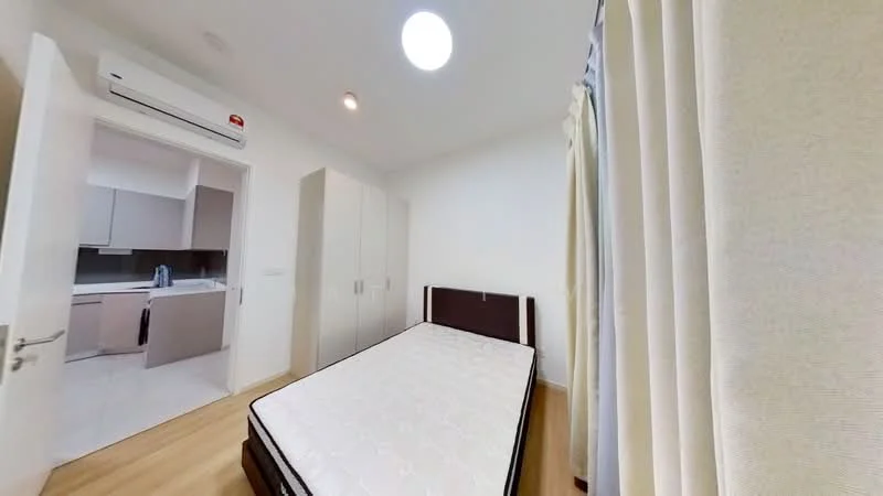 Bedroom features: queen-size bed, light wood flooring, white painted walls, built-in wardrobe with sliding doors, ceiling light, wall-mounted split AC, curtains, window with natural light; style: modern. Kitchen features: kitchen cabinetry, countertop, sink, stainless-steel appliances, open layout to bedroom; style: modern.