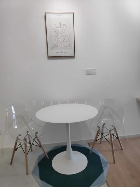 Dining features: round white dining table, two clear acrylic chairs with wooden legs, white painted walls, decorative framed artwork on wall, green and blue geometric area rug; style: minimalist.