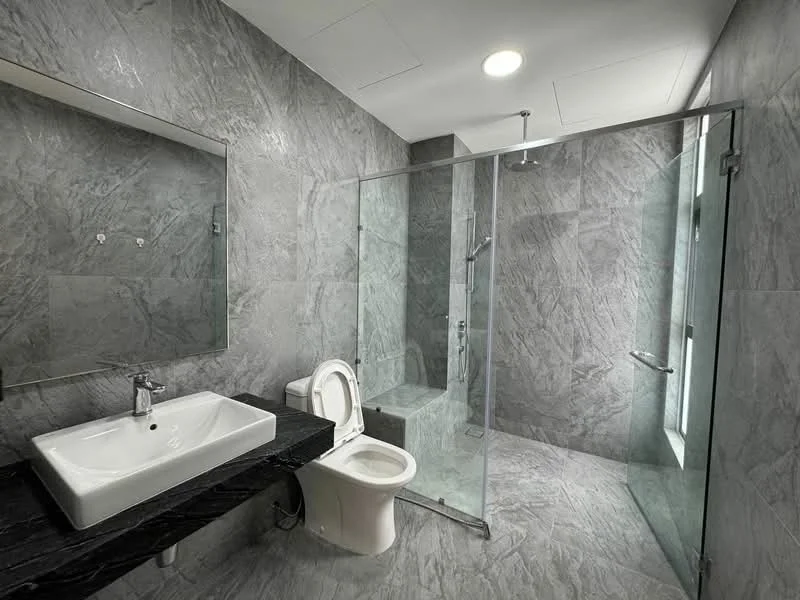 Bathroom features: grey marble wall tiles, grey marble floor tiles, single-sink vanity with black countertop, chrome basin mixer faucet, framed mirror, one-piece toilet, walk-in shower with glass enclosure, rain shower head, recessed ceiling lights, glass shower partition; style: modern.