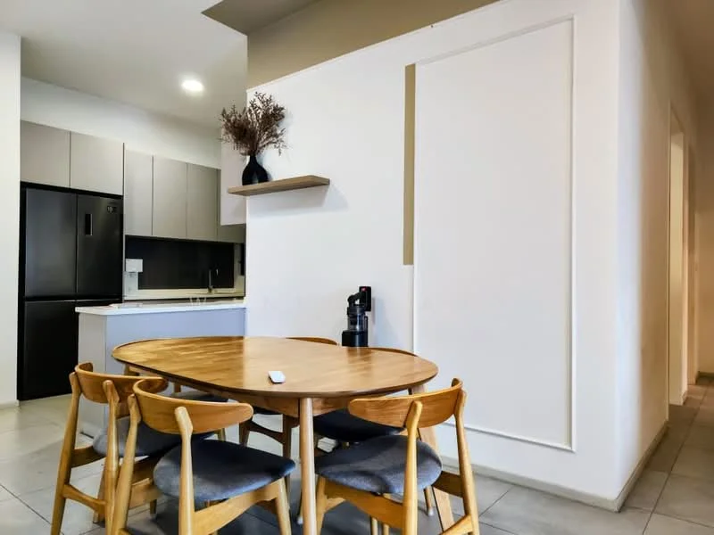 Dining features: round wooden dining table, 4 wooden dining chairs with grey upholstery, white painted walls, grey cabinetry, black refrigerator, kitchen countertop, shelf with decorative vase, tile flooring, recessed ceiling lights; style: modern.