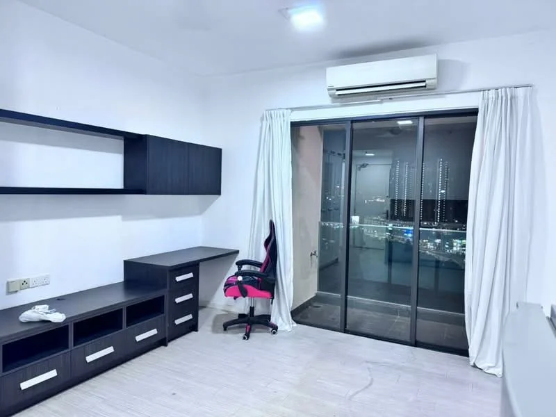 Room features: light wood flooring, white painted walls, ceiling-mounted air conditioning unit, floor-to-ceiling sliding glass door, sheer white curtains, black wall-mounted shelving unit, black desk with drawers, pink office chair, city skyline view visible through glass door, recessed ceiling lights; style: modern; view: city.