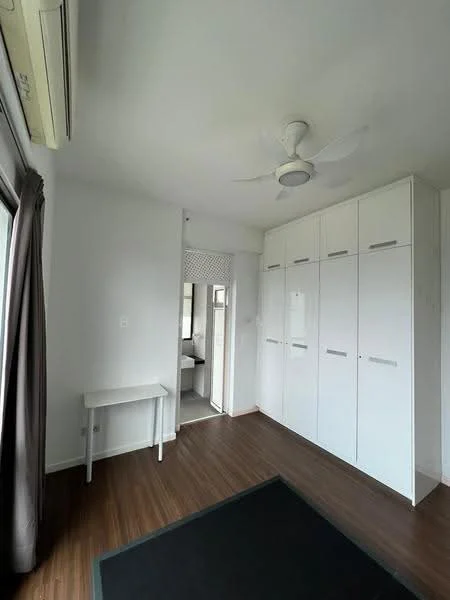 Room features: white painted walls, laminate flooring, 5-blade ceiling fan with light, built-in wardrobe with multiple doors, window with sheer curtains, small table, air conditioning unit; style: modern.