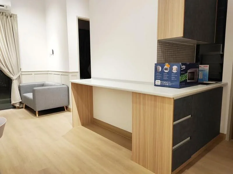 Kitchen features: light wood cabinetry, dark grey cabinetry, white countertop, tile backsplash, built-in microwave, open layout, laminate flooring, recessed lighting; style: modern. Living features: grey fabric sofa, curtains, wall-mounted light, decorative wall paneling; style: modern.