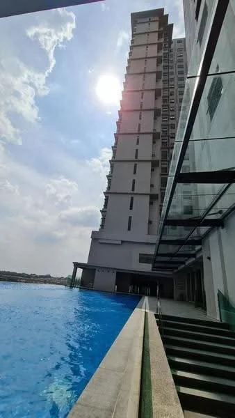 Exterior type: high-rise condominium; features: infinity pool, glass railing, concrete facade, swimming pool deck, landscaped area, large windows, multiple storeys, sunlight reflection on water; style: modern.