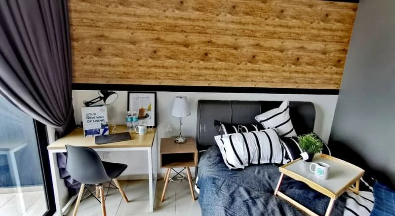Bedroom features: wood accent wall, grey upholstered bed, black and white striped bedding, side table with lamp, study desk with chair, decorative plant, framed artwork, floor-to-ceiling window with curtain, light-colored flooring; style: modern.