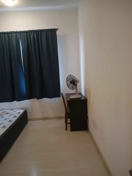 Bedroom features: blackout curtains, single bed frame, mattress on bed frame, wooden flooring, desk with chair, table fan, white painted walls.