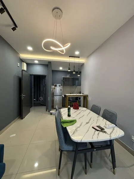 Dining features: marble dining table, upholstered dining chairs in blue, pendant lighting fixture, recessed LED downlights, grey painted walls, glossy tile flooring, open kitchen layout, kitchen island visible in background, green placemat, bottle on table, smartphone on table; style: modern. Kitchen features: stainless-steel fridge, kitchen cabinetry, open shelving, countertop, kitchen appliances visible; style: modern.