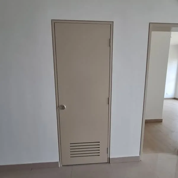 Room features: cream painted walls, light wood flooring, single door with ventilation grill, door handle, trim around door frame; style: modern.