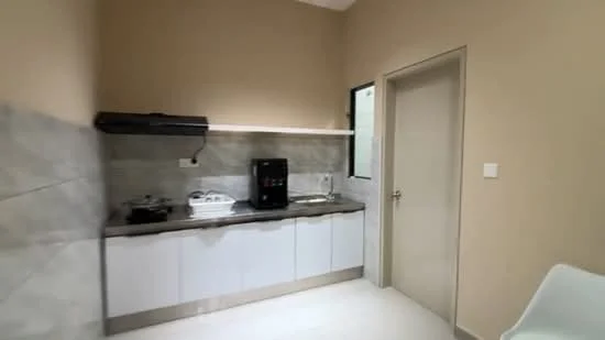 Kitchen features: white cabinetry, grey marble countertop, stainless-steel sink, chrome pull-down faucet, built-in gas stove, black range hood, white tiled backsplash, refrigerator, light-colored walls, tile flooring; style: modern.