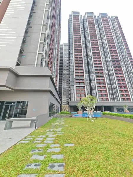 Exterior type: high-rise condominium; features: glass curtain wall, grey painted facade, red accent panels, manicured lawn, stone-paved walkway, swimming pool visible, landscaped garden, multiple storeys, modern architectural design; style: modern.