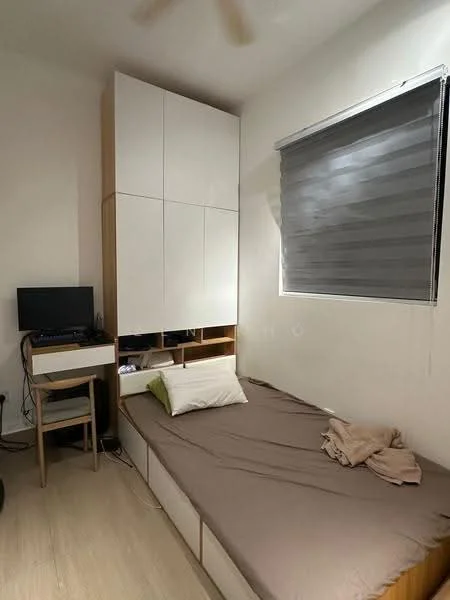 Bedroom features: single bed with brown bedding, white built-in wardrobe with upper storage, wooden desk with chair, black monitor on desk, grey roller blinds on window, light wood flooring, ceiling fan, decorative pillow on bed, wall-mounted storage unit; style: modern.