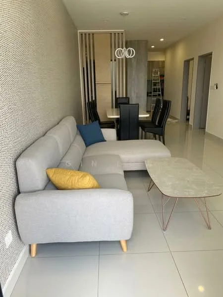 Living features: L-shape sectional sofa in grey fabric, decorative yellow cushion, coffee table with marble top and metal legs, wall with textured surface, recessed ceiling lights, dining table with black chairs, open layout, large floor tiles in light color; style: modern.