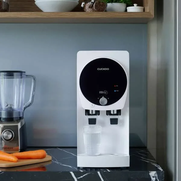 Kitchen features: water dispenser, black countertop, wooden shelving, blender, carrots on countertop; style: modern.