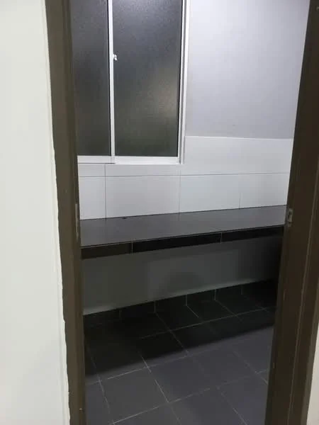 Laundry features: grey tiled flooring, white tiled walls, black countertop, window with frosted glass, built-in cabinetry, shelving above countertop.