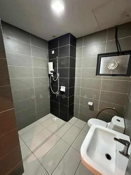 Bathroom features: grey tile walls, black accent wall, white ceramic sink, one-piece toilet, shower with glass enclosure, wall-mounted shower head, chrome faucet, recessed ceiling lights, floor tiles, drain in floor; style: modern.