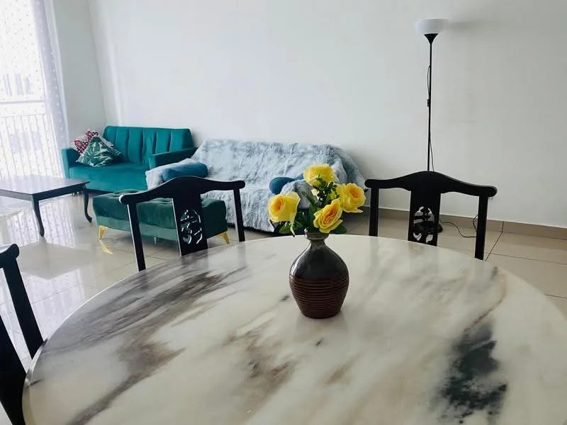 Dining features: round marble dining table, black wooden dining chairs, yellow roses in a vase, cream tiled flooring, white painted walls, sofa in teal fabric, sofa in light blue fabric, floor lamp; style: modern.