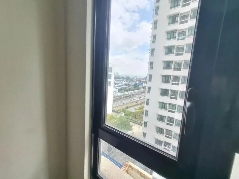 Room features: black framed window, city view, partially visible building exterior, cloudy sky; view: city.