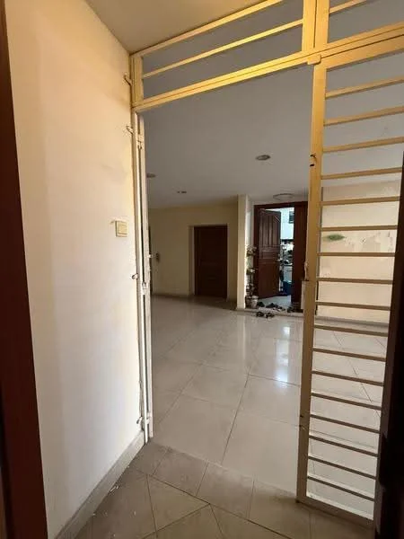 Room features: white painted walls, cream tiled flooring, double wooden doors, metal security gate, recessed ceiling lights, open layout, visible hallway, neutral color scheme; style: modern.