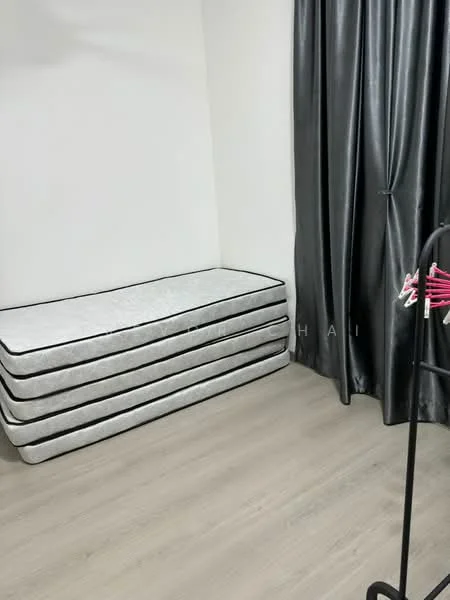 Room features: stacked mattresses, grey curtains, light wood flooring, white walls.