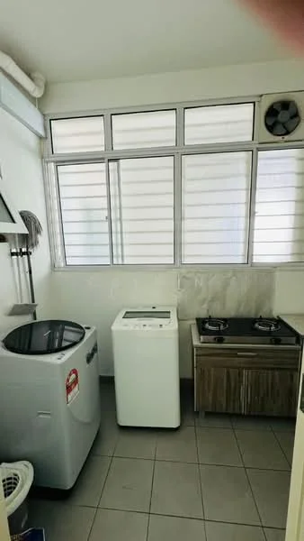Laundry features: washing machine, dryer, 2-burner gas hob, stainless-steel sink, wood cabinetry, grey tiled flooring, window with horizontal slats, exhaust fan.