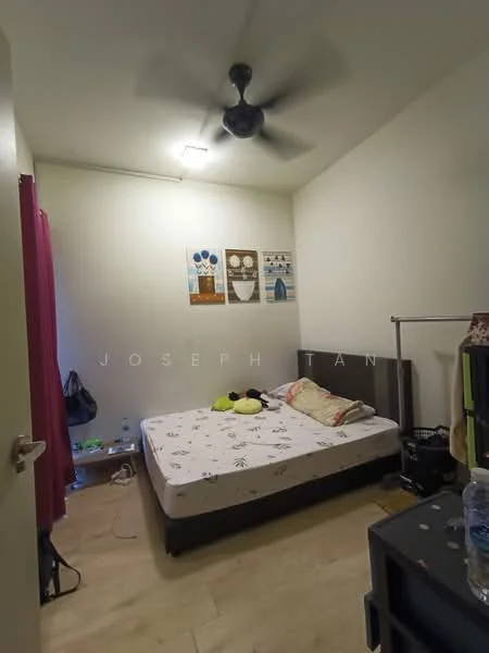 Bedroom features: queen-size bed, upholstered headboard, 2 bedside lamps, wooden flooring, ceiling fan, white painted walls, framed artwork on walls, nightstand, water bottle on nightstand, clothes on floor.