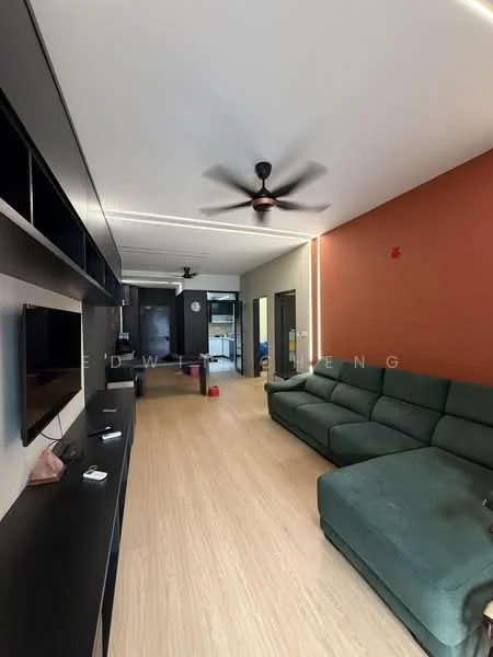 Living features: L-shape sectional sofa in green, wall-mounted TV, black entertainment unit, light wood flooring, 5-blade ceiling fan, recessed LED strip lighting, accent wall in terracotta, open layout to kitchen, decorative wall clock; style: modern.