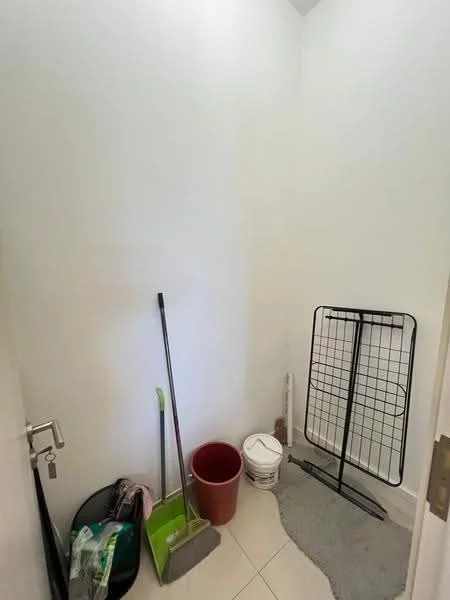 Room features: white painted walls, tile flooring, cleaning supplies, mop, bucket, clothes drying rack, trash bin, storage bucket.