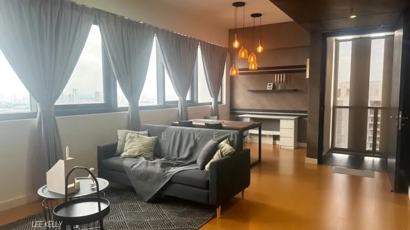 Living features: grey fabric sofa, decorative throw blanket, black coffee table, area rug with geometric pattern, floor-to-ceiling windows, curtains in grey, pendant lighting with amber glass shades, wooden accent wall, built-in desk with shelving, wooden flooring, city view; style: modern; view: city.