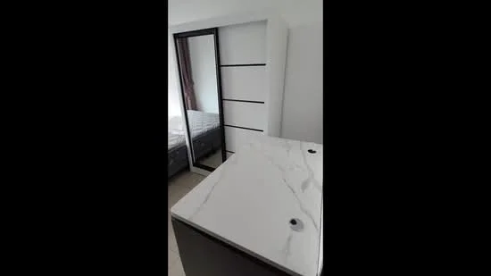Room features: white marble countertop, built-in wardrobe with sliding doors, grey bedding, light-colored walls, tile flooring; style: modern.