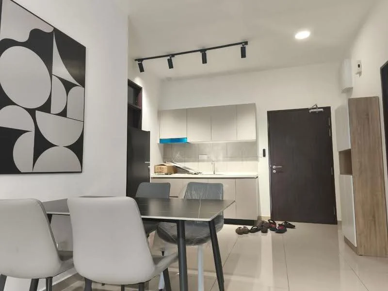 Dining features: 4-seater dining table, grey upholstered dining chairs, white walls, recessed downlights, tile flooring, black framed artwork on wall, open kitchen layout, kitchen cabinets with flat-panel design, grey countertop, kitchen backsplash with tile, door leading to hallway, shoes on floor; style: modern. Kitchen features: white cabinets, grey countertop, built-in kitchen appliances, tile backsplash, recessed lighting; style: modern.