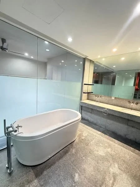 Bathroom features: freestanding bathtub, chrome floor-mounted faucet, double-sink vanity with stone countertop, wall-mounted mirror, glass shower enclosure, recessed downlights, grey stone flooring, glass partition, built-in shelving, modern ceiling fan; style: modern.