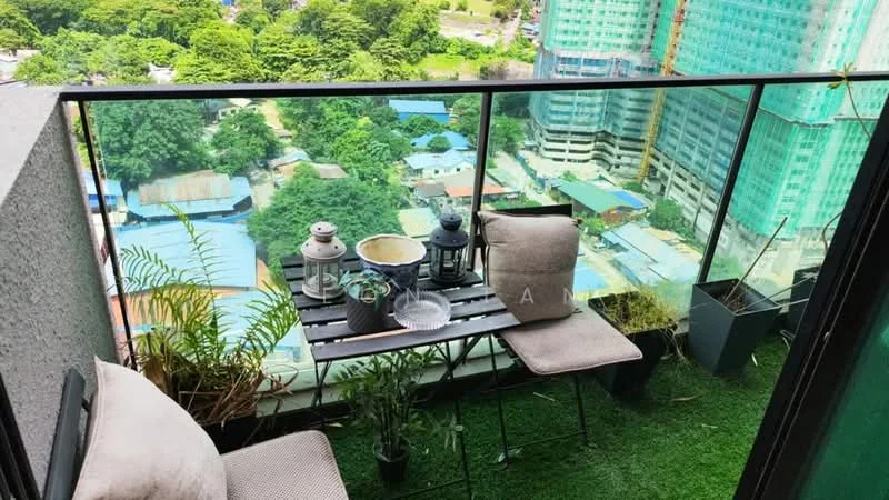 Balcony features: glass railing, artificial grass flooring, small outdoor table, two outdoor chairs, potted plants, city view, lanterns; style: modern; view: city.