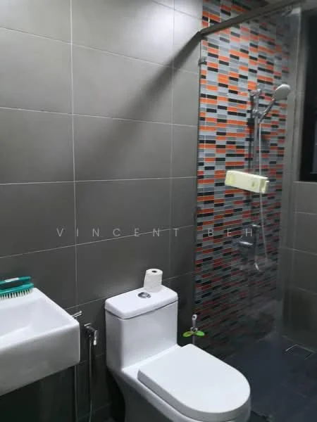 Bathroom features: grey ceramic tile walls, mosaic tile accent wall with orange and black pattern, glass shower enclosure, rain shower head, handheld shower, single-sink vanity with white cabinet, one-piece toilet, toilet paper holder, soap dispenser, small potted plant; style: modern.