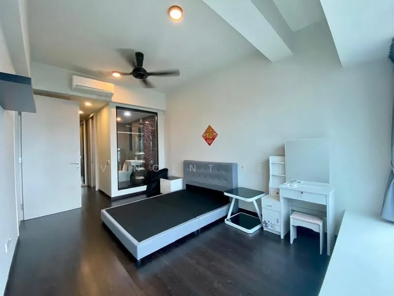 Bedroom features: dark wood flooring, white painted walls, 5-blade ceiling fan, built-in wardrobe with sliding doors, queen-size bed with grey upholstered headboard, white study desk, white chair, decorative wall art, recessed lighting, glass door leading to bathroom, window with sheer curtains; style: modern.