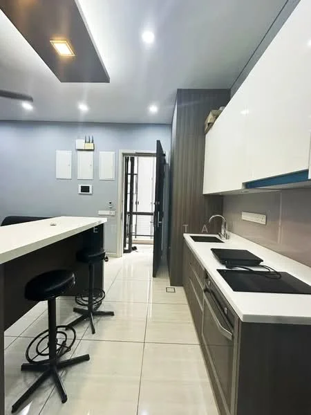 Kitchen features: white cabinetry, grey accent wall, marble countertop, stainless-steel sink, built-in stove, bar counter with seating, black bar stools, tile flooring, recessed ceiling lights, wall-mounted appliances, open layout, doorway leading to hallway; style: modern.