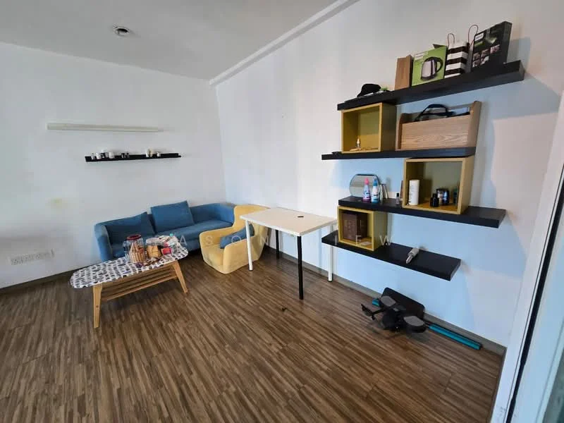 Living features: blue fabric sofa, yellow accent chair, coffee table with patterned top, black floating shelves, wooden shelving unit, laminate wood flooring, wall-mounted light fixture, decorative items on shelves, bottle of cleaning spray, exercise equipment on floor; style: modern.