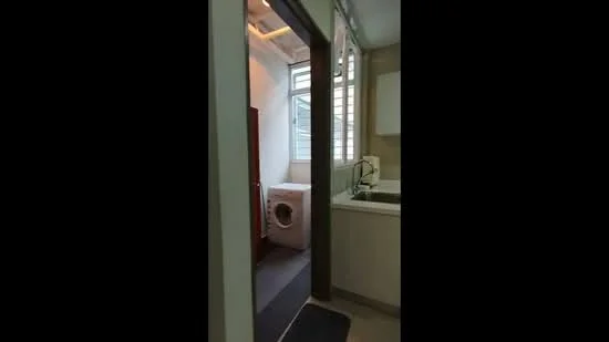 Laundry features: washing machine, sink, white cabinetry, grey wall tiles, window with louvered design, grey floor mat, light fixture, white walls; style: modern.