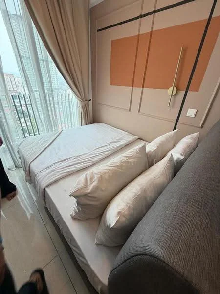 Bedroom features: queen-size bed, upholstered headboard, decorative pillows, floor-to-ceiling windows, sheer curtains, cream painted walls, accent wall with orange panel, laminate flooring, wall-mounted light fixture, side table with lamp, sofa, decorative wall art; style: modern; view: city.