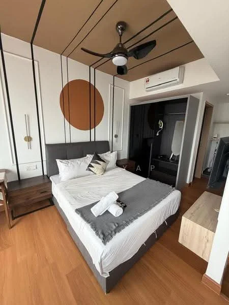 Bedroom features: queen-size bed, upholstered headboard, white bedding, grey throw blanket, 2 white towels, wooden bedside table, table lamp, wall-mounted TV, ceiling fan with light, air conditioning unit, wooden flooring, decorative wall art, accent wall with circular design; style: modern.